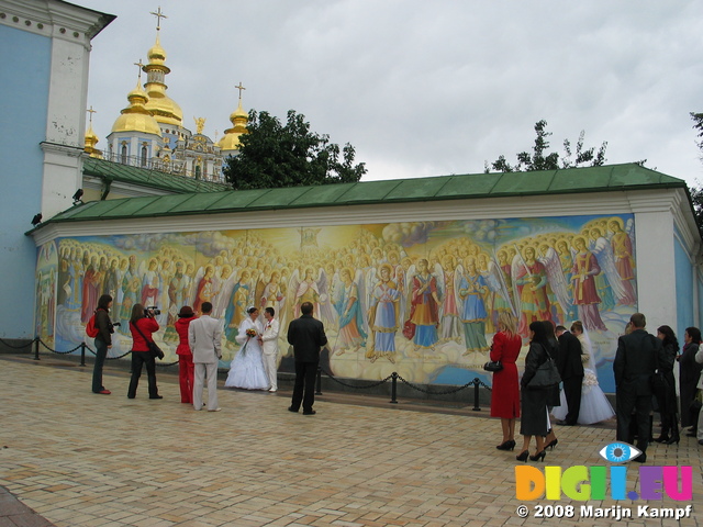 28277 Newly weds at mural by St. Michael's golden domed cathedral